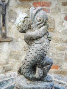 Statue of a cherub having sex with a fish. Westerham, Kent.