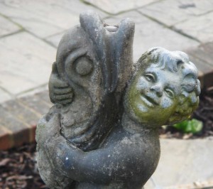 Contrasting expressions on cherub and fish