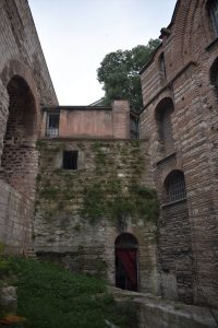 The arch at the bottom leads into the apse of the 6th century church. At left is the aqueduct, at right is the late 12th century church