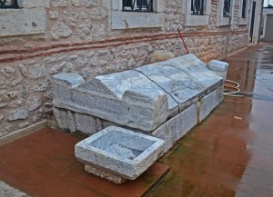 Sarcophagus and capital against the wall of Agios Stefanos