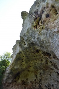 The biggest cave in the area has a mystery awning of sticks above it