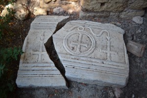 A section of marble sarcophagus that has fallen from the church