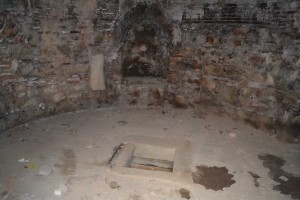 The hole in the floor through which the sacred spring may have been accessed
